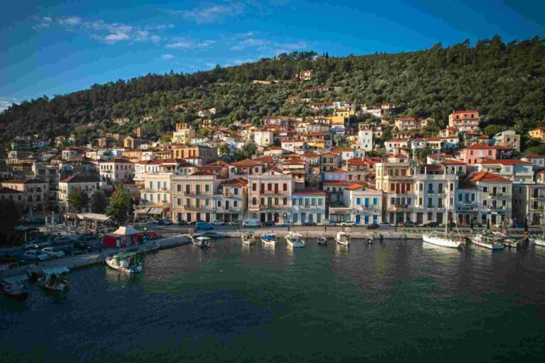 a city on a hill with boats on the water